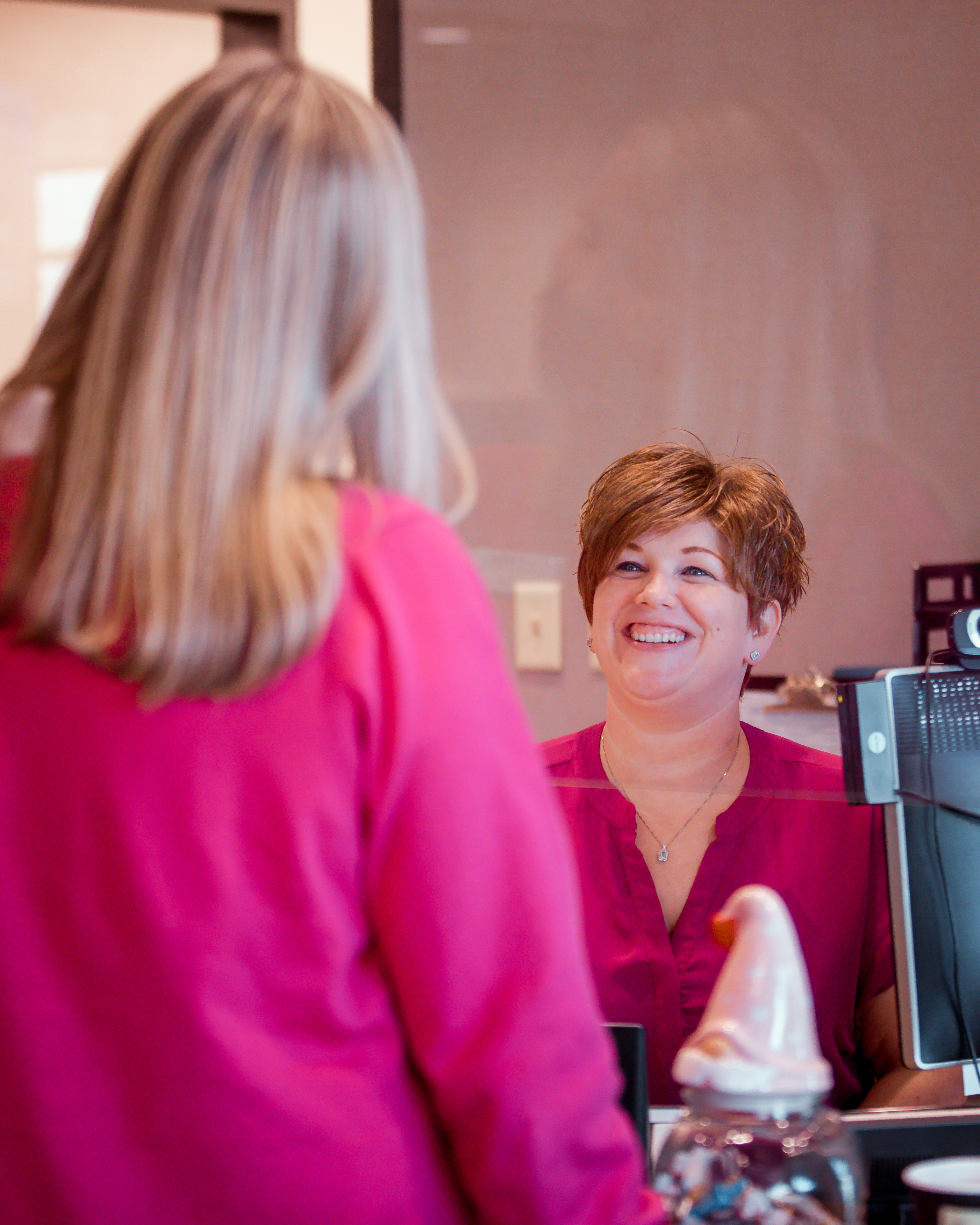 Receptionist welcoming patients