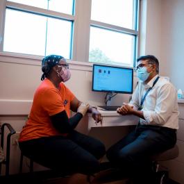 Dr. Mosalpuria with patient in exam room