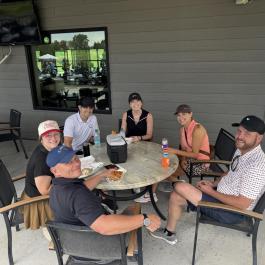 Golfers enjoying beverages outside of clubhouse