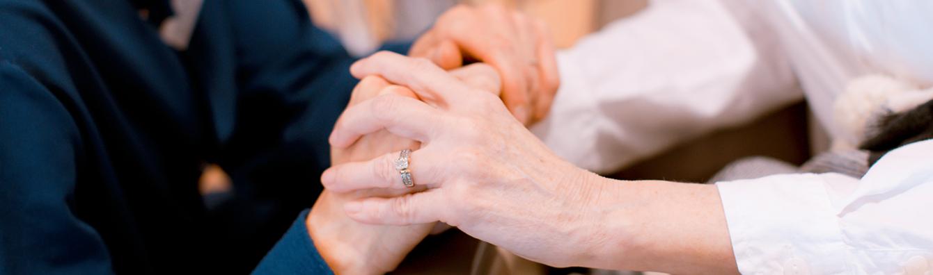 Patient and Nurse holding hands