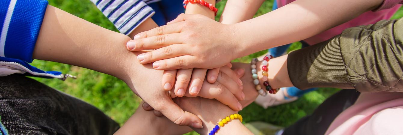 Children with hands in huddle