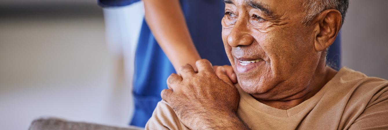 Man receiving support from nurse.